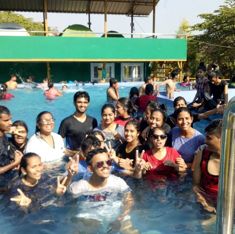 a group of people standing in a pool