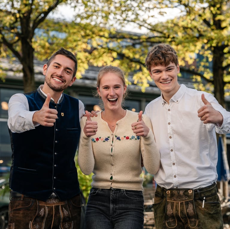 three people standing next to each other with thumbs up