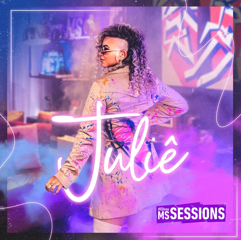 Singer Juliê performs at MS Sessions in a paint-splattered jacket with curly hair and sunglasses.