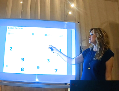 Gina Danford standing in front of a large screen at a workshop