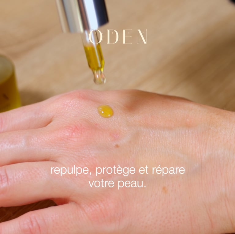 a person's hand holding a bottle of oil cosmetic