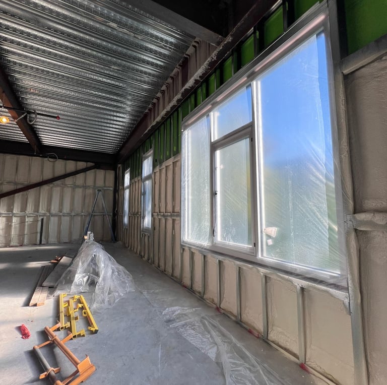 Spray foam metal building