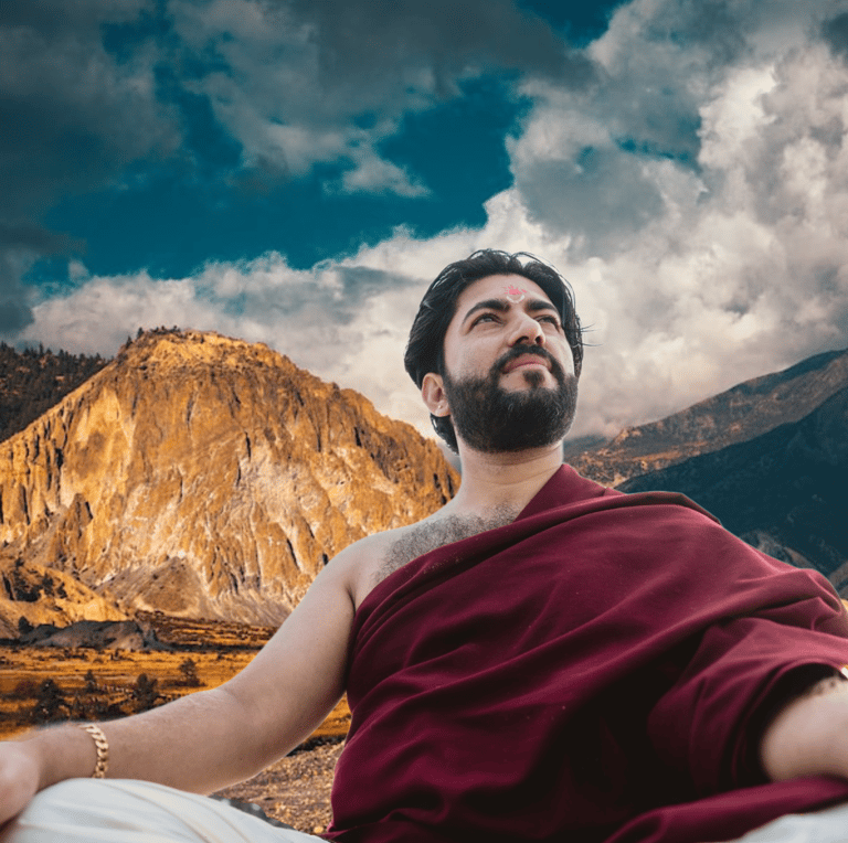 a man sitting on a bed with a mountain in the background