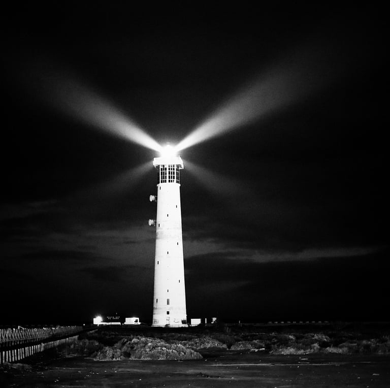 a lighthouse at night with a bright light shining from it