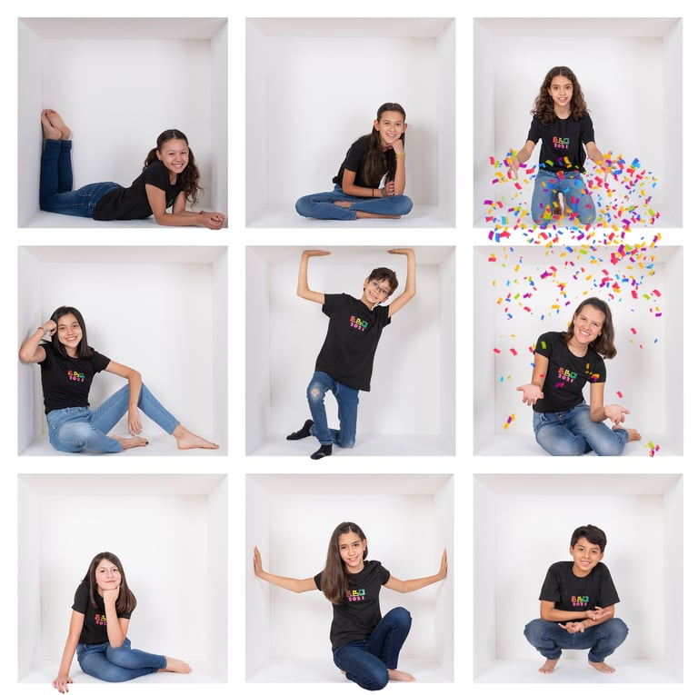 a woman in a black shirt and jeans sitting on a white wall