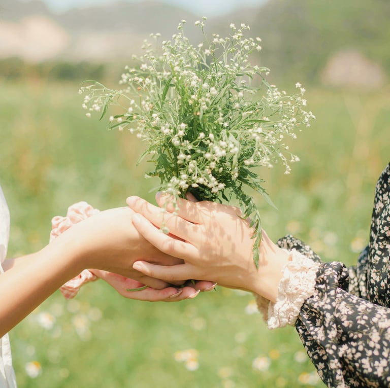 a woman holding a small plant in her hands and sharing with a friend