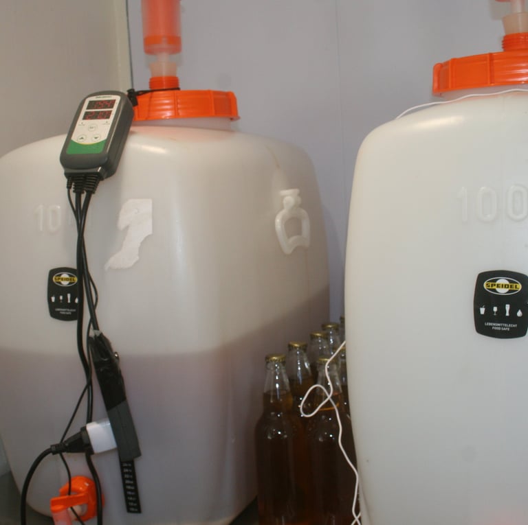 two large white containers with orange lids and a remote control