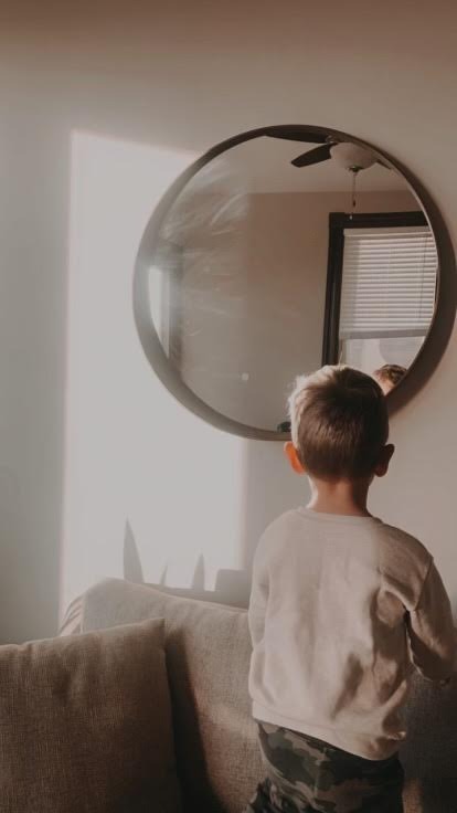 child looking into a round mirror recommending email subscription for nutrition and wellness help