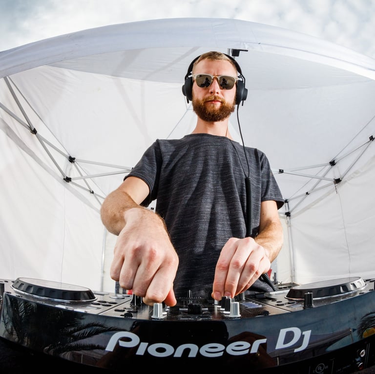 a man in a black shirt and headphones on a dj - set
