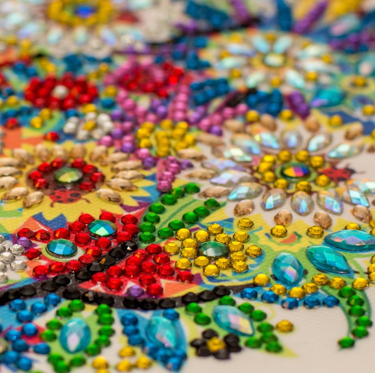 a close up of a colorful embroided rhinestone on a table