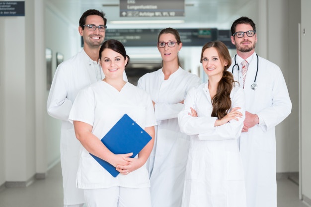 a group of doctors and nurses in white coats and lab coats
