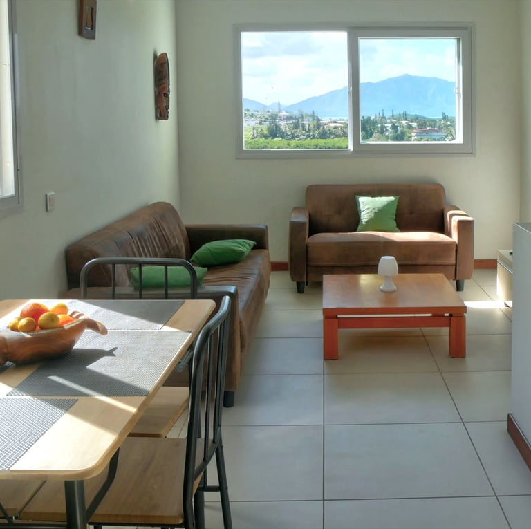 a living room with a table and chairs