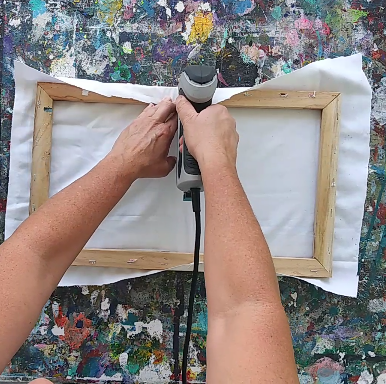 a person using stapler gun