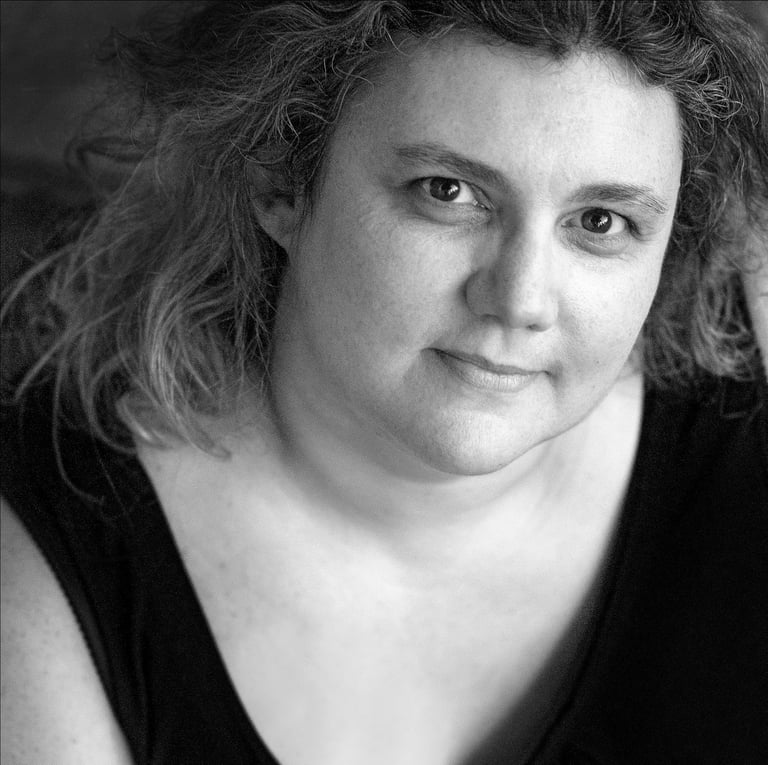 a woman with curly hair and a black top