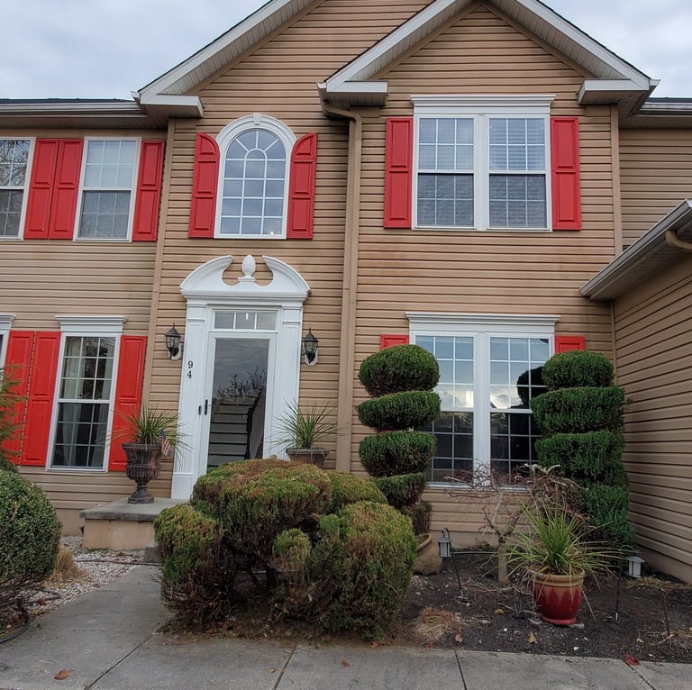 a house with red shutter shutters and red shutters