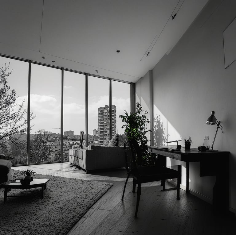 a living room with a couch, a table and great views out the window