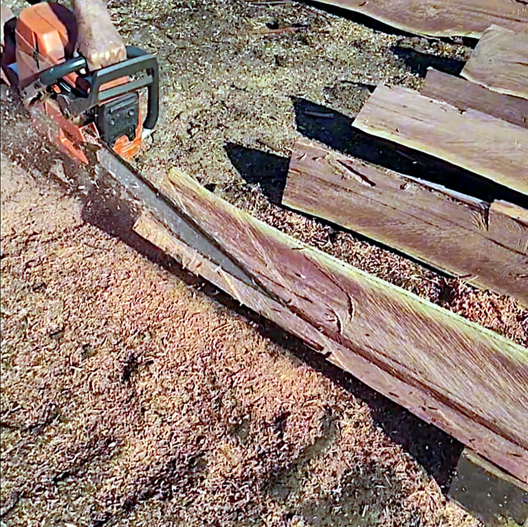 Facing fence post with chainsaw