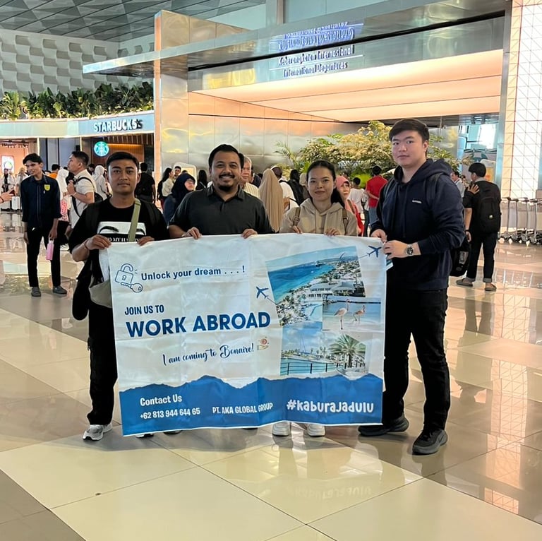 Crew ready for boarding, holding AKA banner at Soekarno-Hatta International Airport.