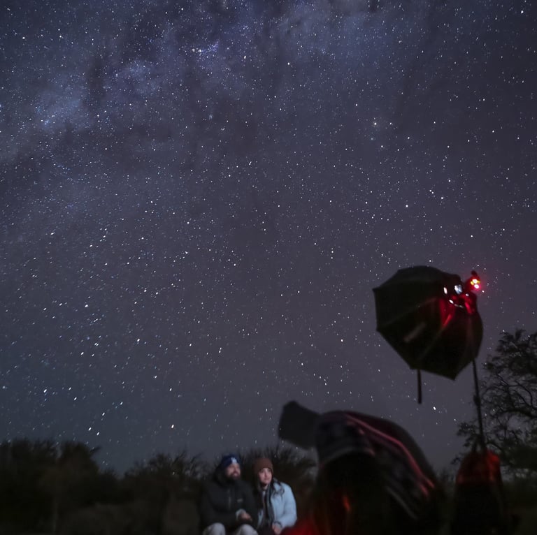 a group of people sitting under the stars