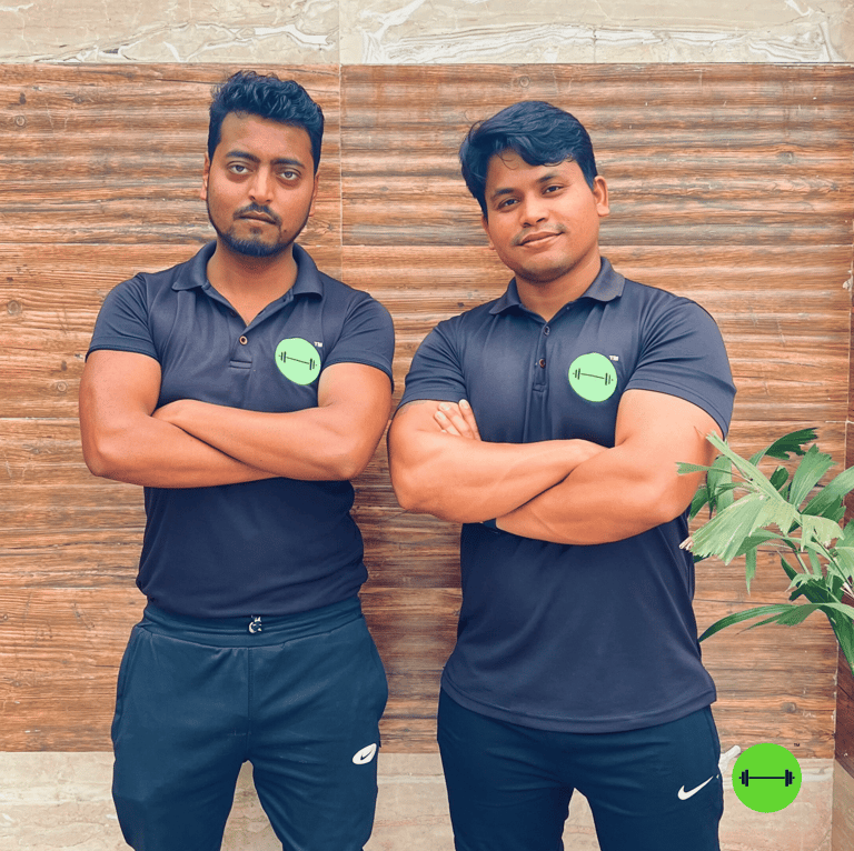 two men standing next to each other with their arms crossed