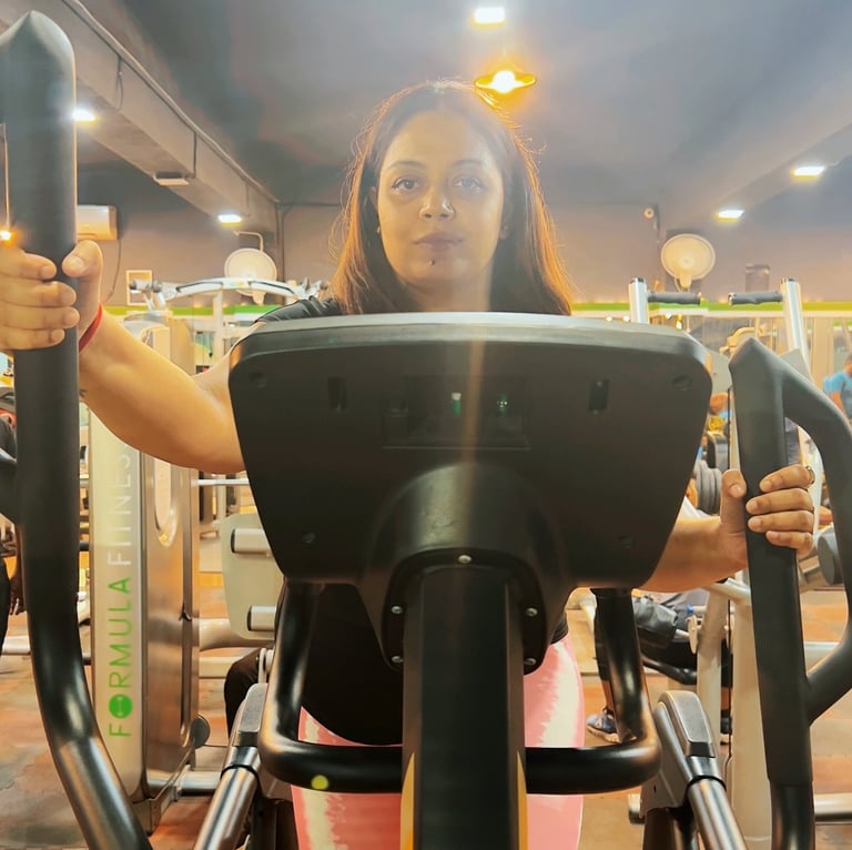 a woman is standing on a stationary stationary stationary stationary exercise machine