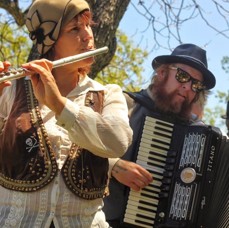Mazel Tov Kocktail Hour founders playing flute and accordion at a show.