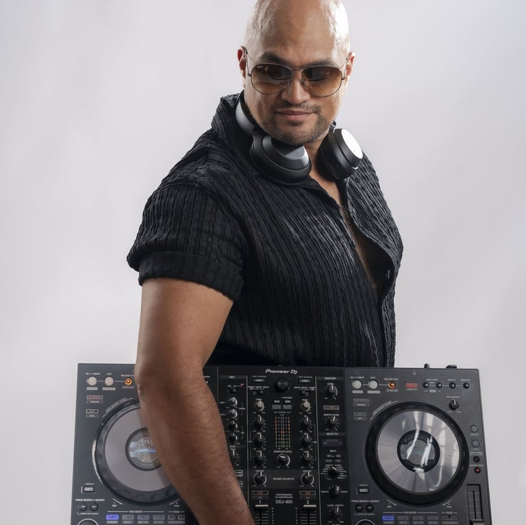 a man in a black shirt and sunglasses holding a dj controller