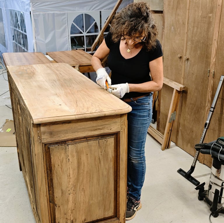 Stéphanie restaurant un meuble ancien dans son atelier du Périgord