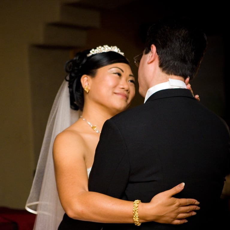 Bride and Groom. First dance contemplating and smiling at each other.