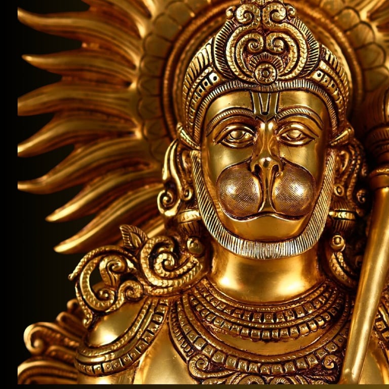 a brass statue of a hanuman with a sword