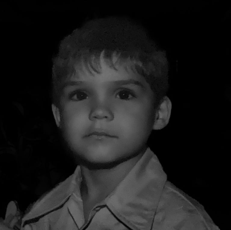 a young boy in a shirt and tie dye dye dye dye dye dye dye dye