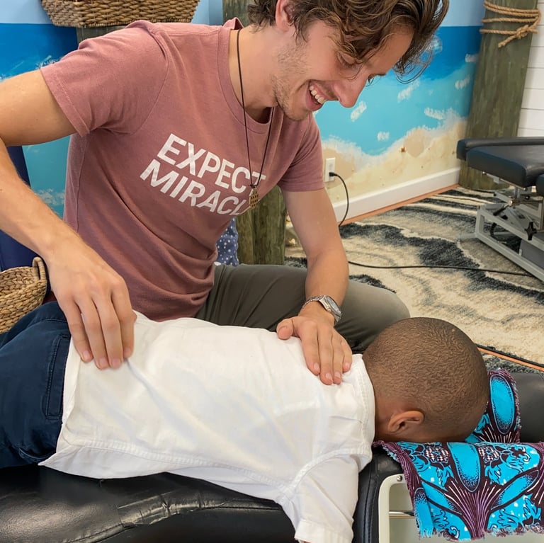 Young child getting adjusted by Franklin pediatric chiropractor