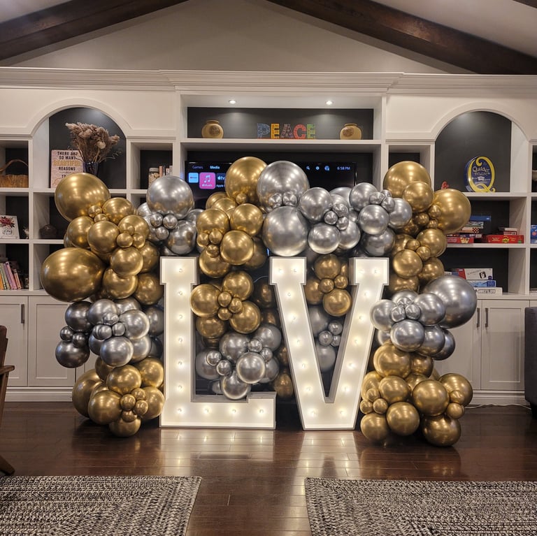 Gold & silver balloons paired with a marquee sign