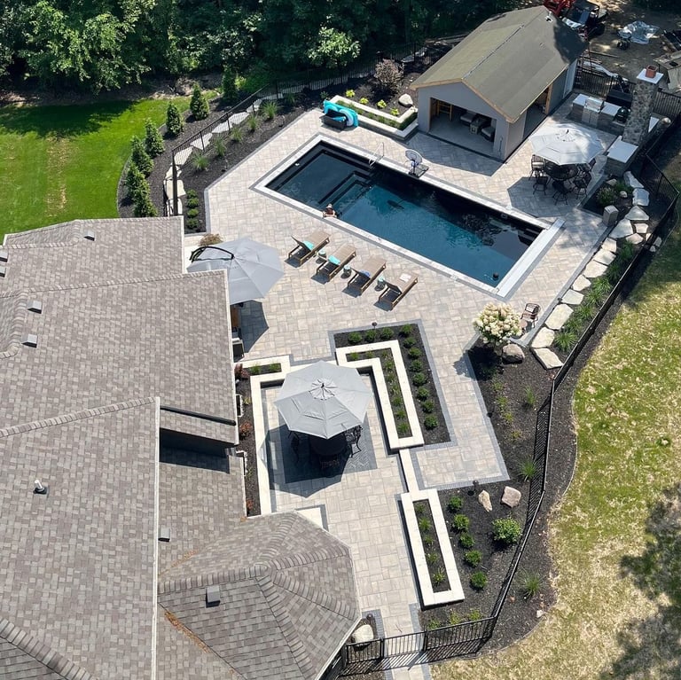 Leppek custom designed patio built in swimming pool. Landscaping, outdoor kitchen, paver patio.