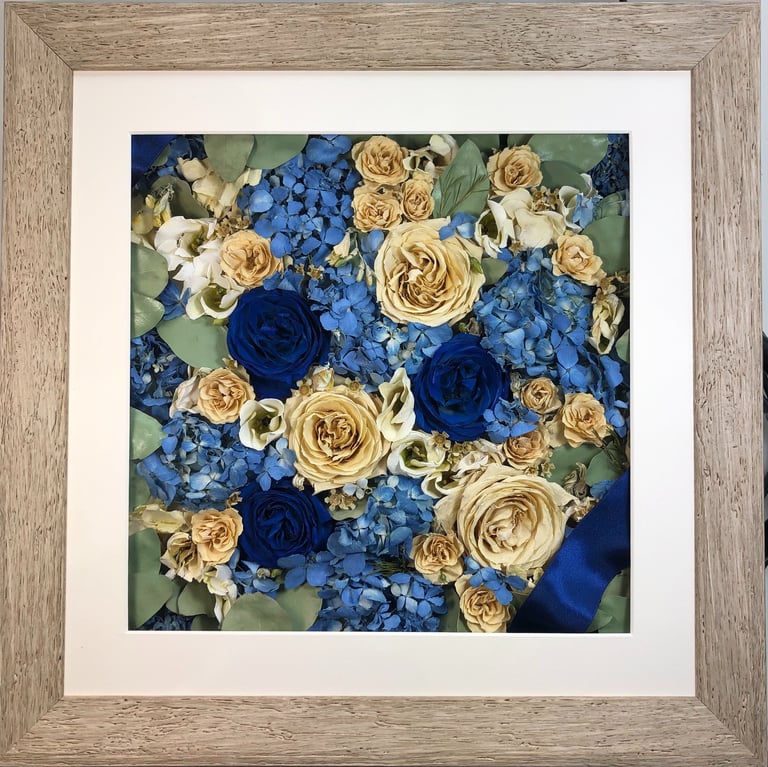 a stunning blue flower wall style preserved wedding bouquet in a frame