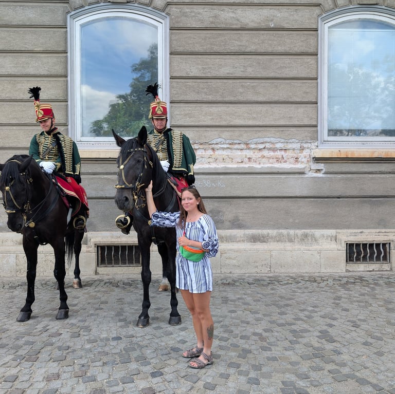 Samantha with Hungarian Hussar guards on black horses at the Buda Castle in Budapest.