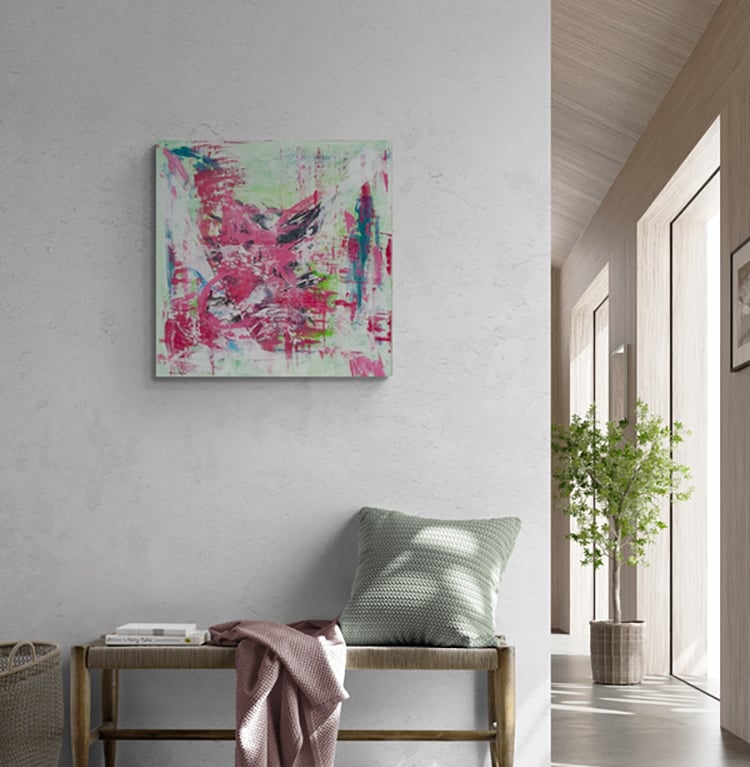 Abstract painting in red and green on wall above bench with cushion