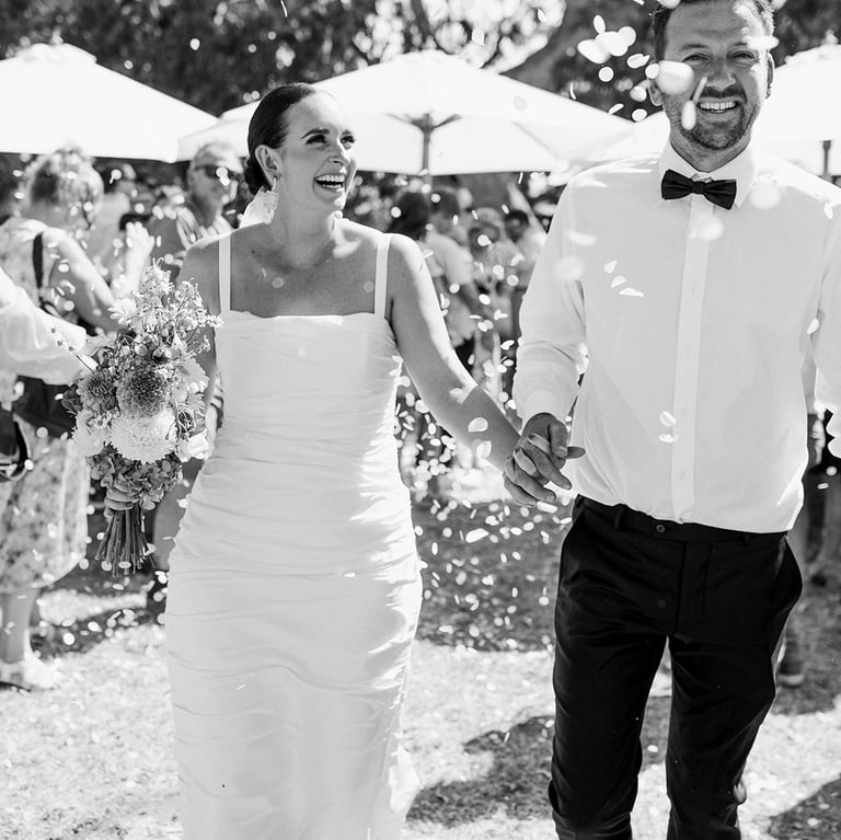Newlyweds walk down the aisle at a Noosa beach wedding ceremony