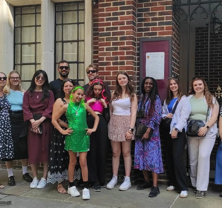 a group of people standing in front of a King's Chapel of Savoy
