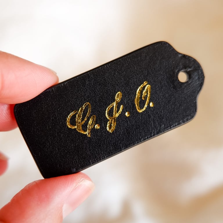 Hot foiling on leather bag tag with initials by NYC calligrapher Handwritten by Belle.