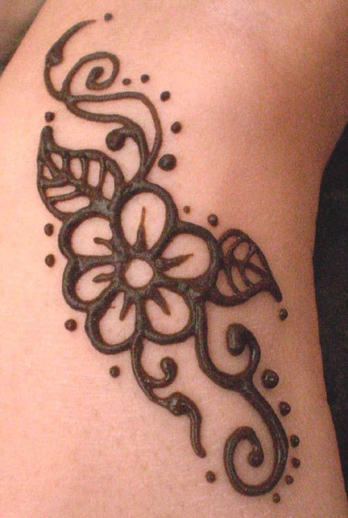 a henna tattoo on a woman's leg of a flower