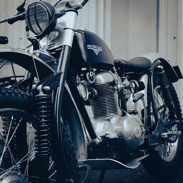 an old motorcycle parked in front of a building