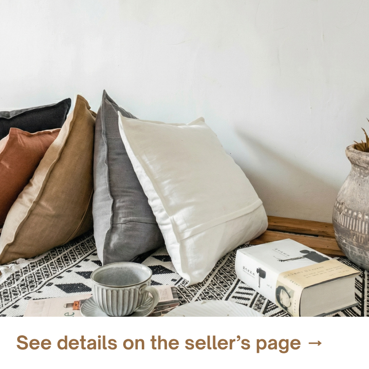 Neutral throw pillows layered on a cozy bed, creating a soft, relaxed look with simple textures and