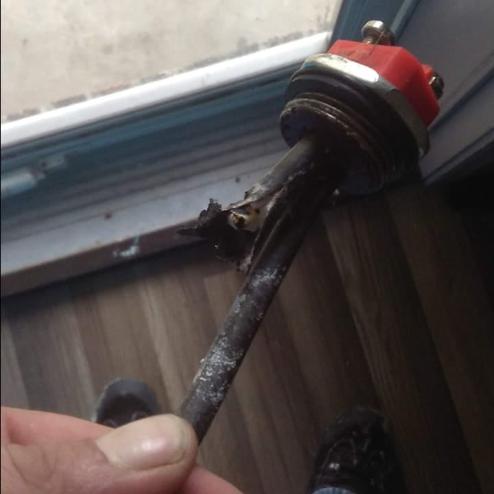 a person holding a small piece of metal in their hand