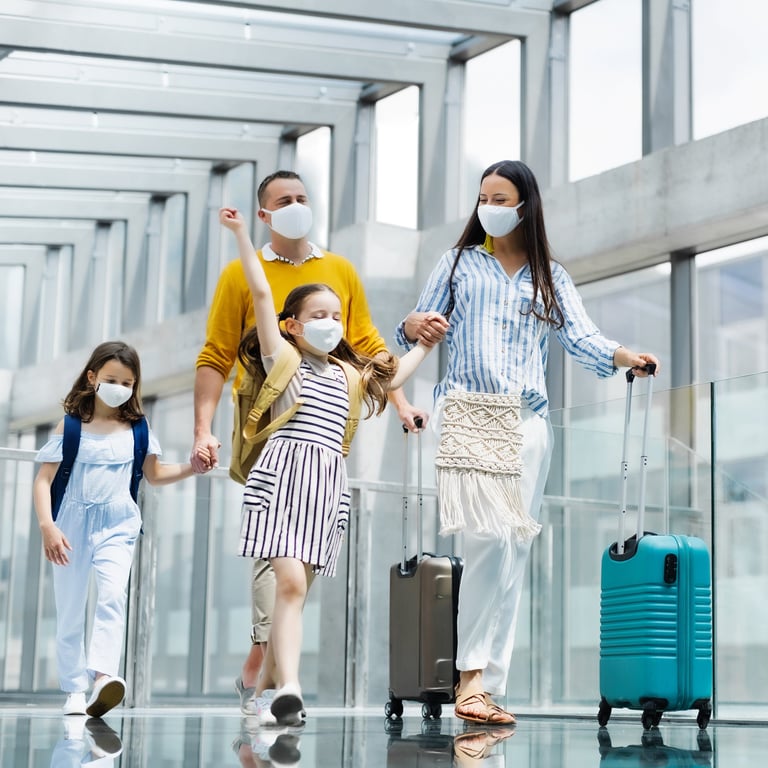 a family of four wearing masks and masks on their faces and travel bag