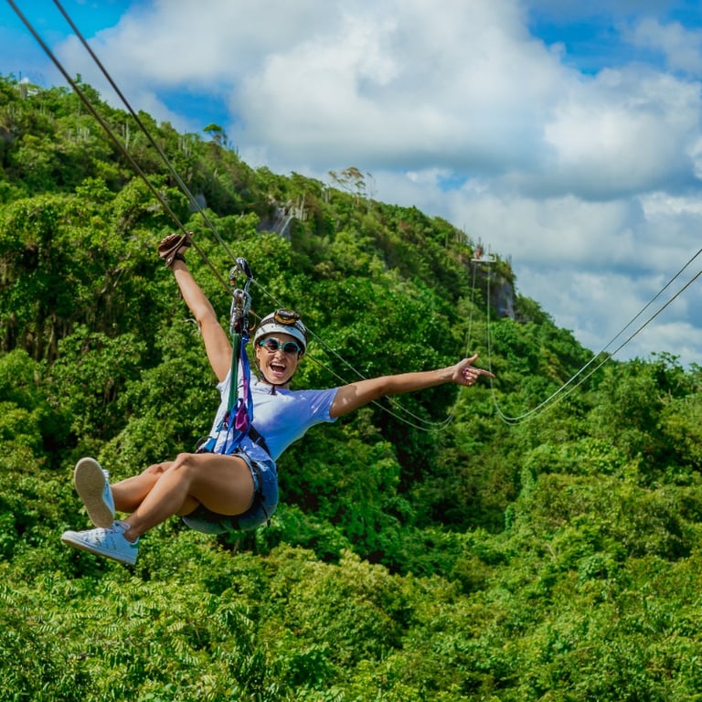a woman is zipping through the jungle canopy scape park punta cana