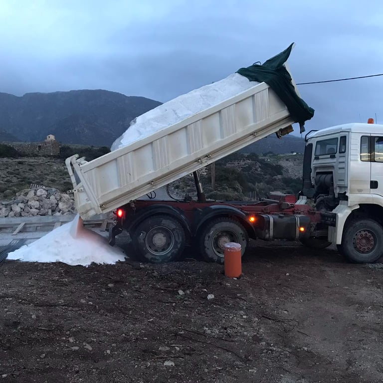 Truck unloading sand at construction site