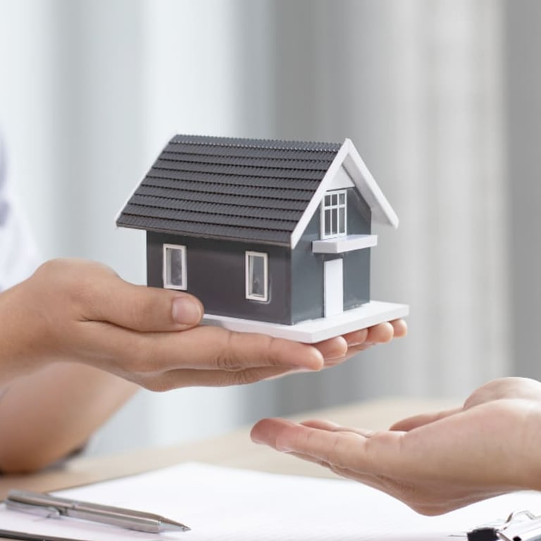 a woman holding a small house model FOR HOME LOANS PROMOTION