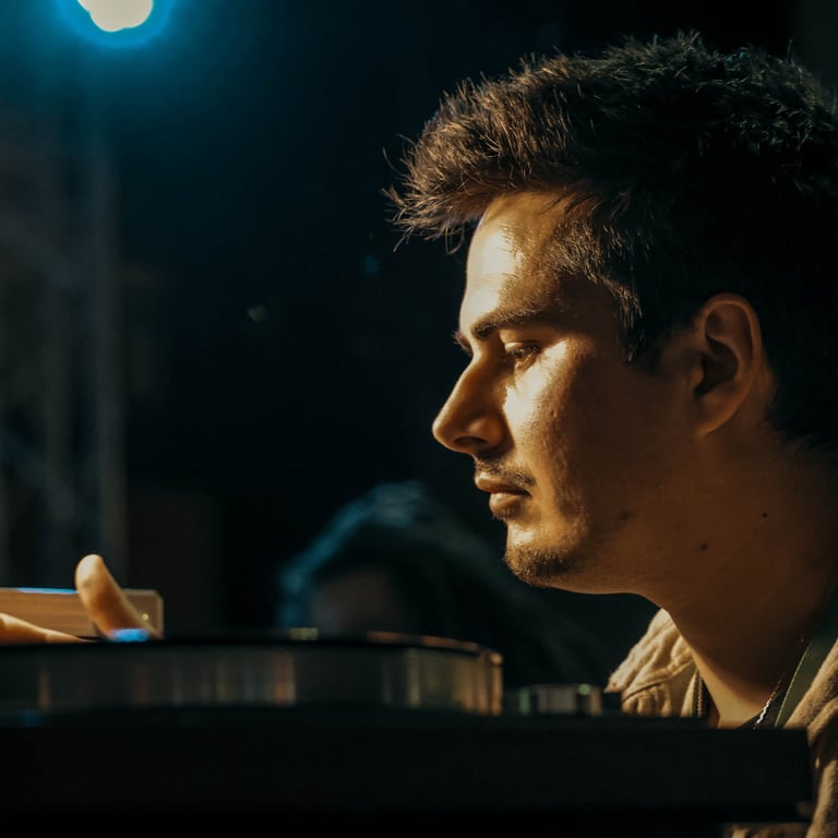 a man sitting at a table with a laptop