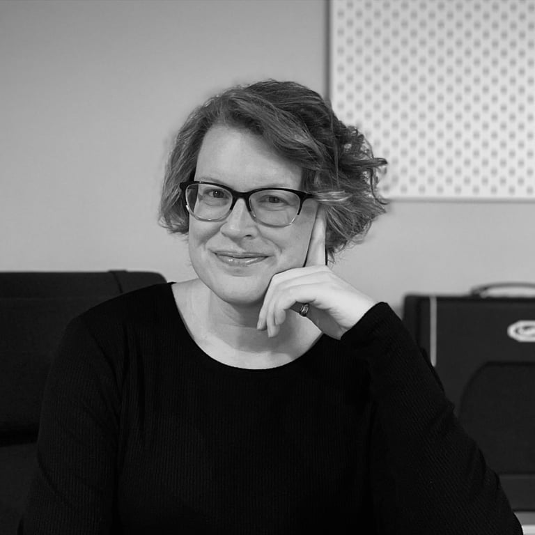 Mary Sherwin, a woman in glasses and a black sweater